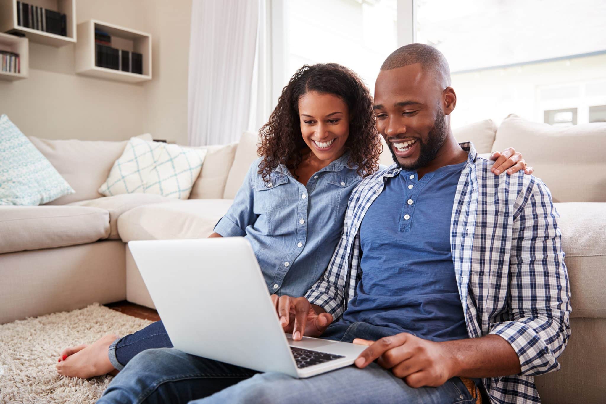 Young,Black,Couple,Using,Laptop,Sitting,On,The,Floor,Parent,Education