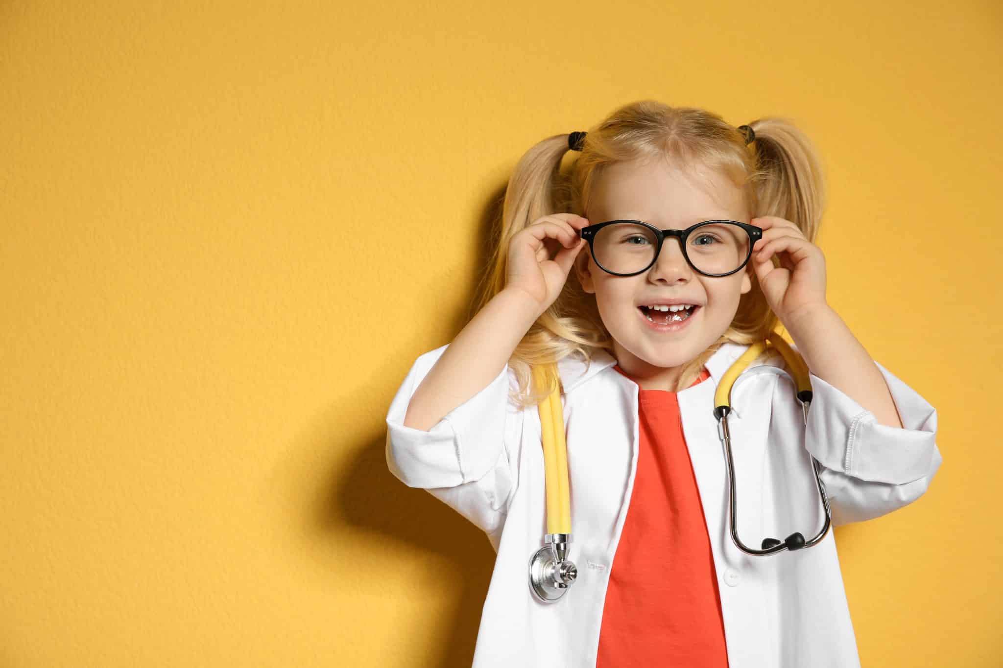 Cute,Child,In,Doctor,Coat,With,Stethoscope,On,Color,Background.