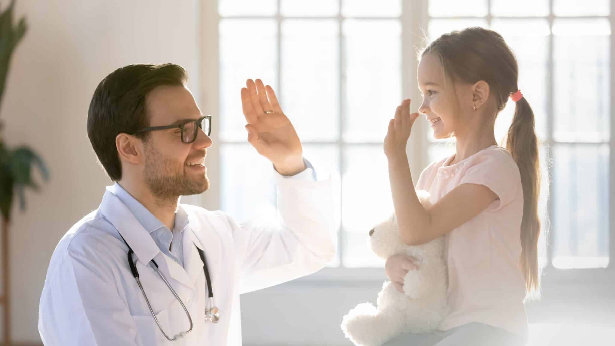 Friendly,Male,Pediatrician,Giving,High,Five,To,Little,Patient,Close