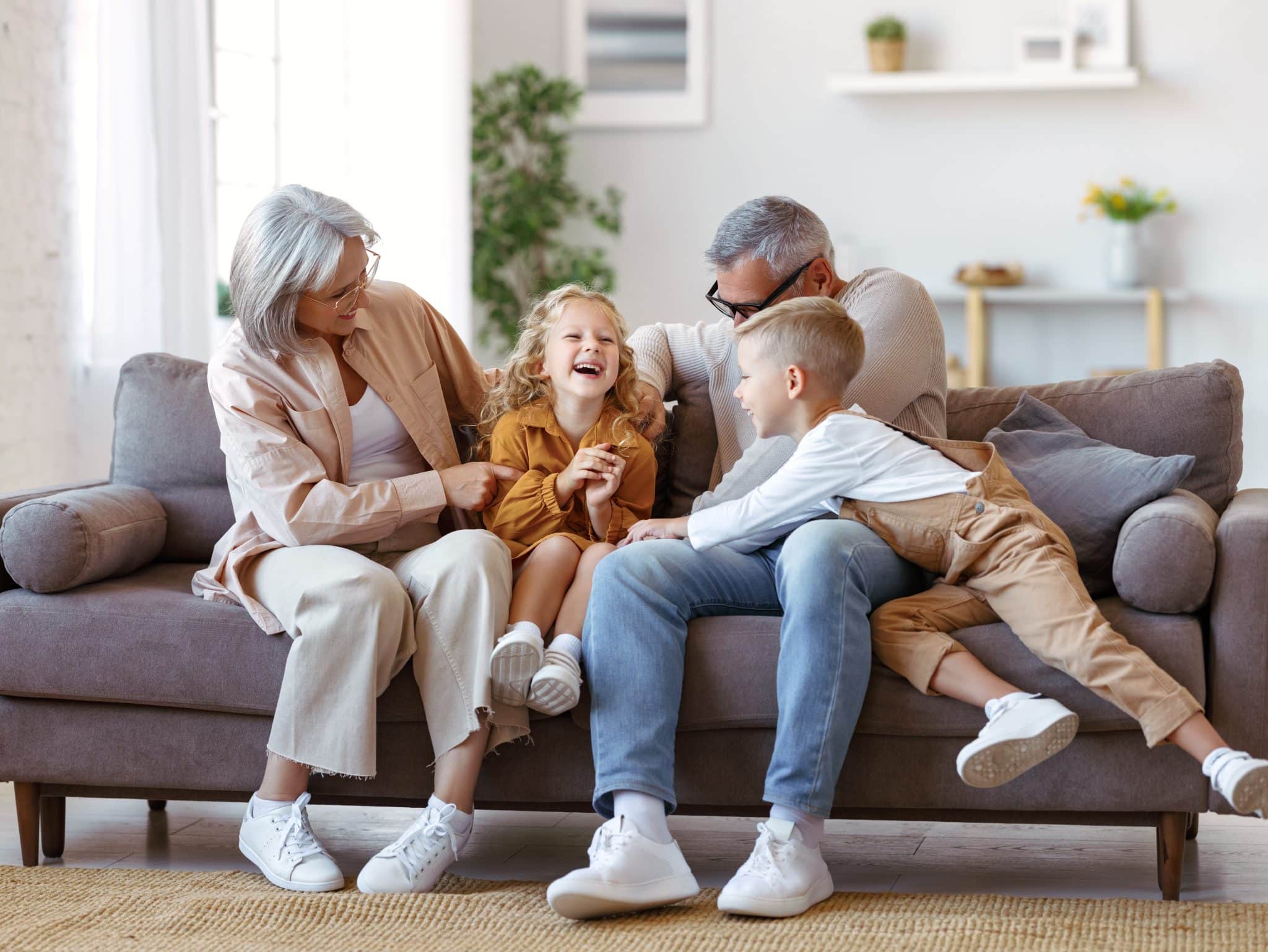 Playful,Kids,And,Grandmother,With,Grandfather,Tickling,Each,Other,While