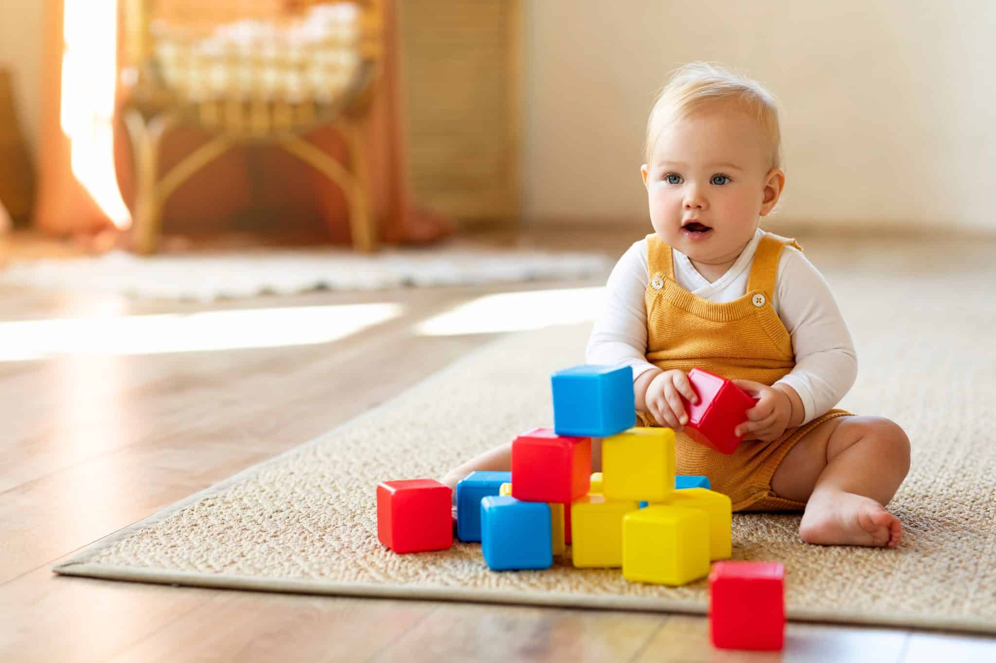 Adorable,Infant,Baby,Playing,With,Stacking,Building,Blocks,At,Home