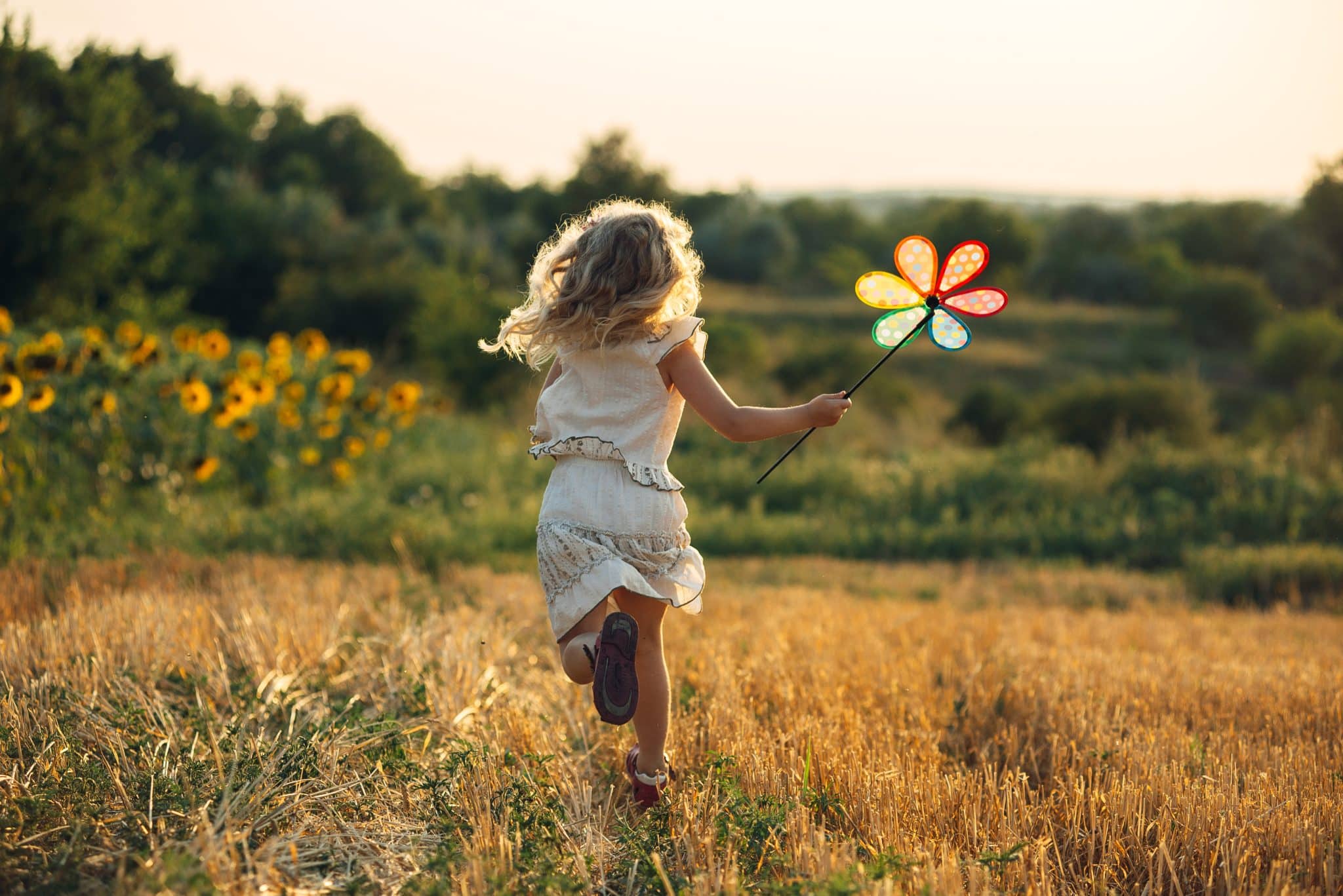 Cute,Little,Girl,Playing,In,The,Summer,Field,Of,Wheat