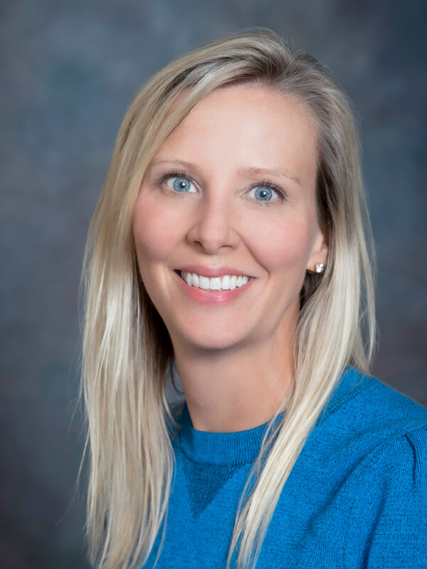 Headshot of Erin Schmidtke, nurse practitioner at South Lake Pediatrics. Erin has blonde hair, is wearing a blue top, and is smiling at the camera.