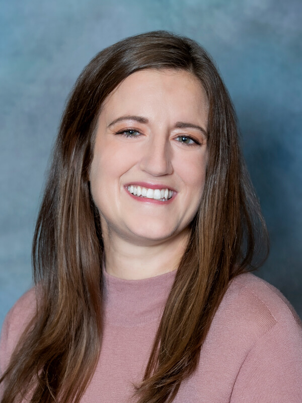 Headshot of Megan Stark, nurse practitioner at South Lake Pediatrics. Megan has long brown hair, is wearing a pink top, and is smiling at the camera.