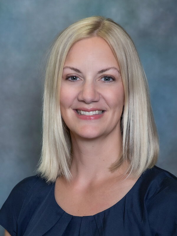 Headshot of Tara Randolph, nurse practitioner at South Lake Pediatrics. Tara has blonde hair, is wearing a navy blue top, and is smiling at the camera.