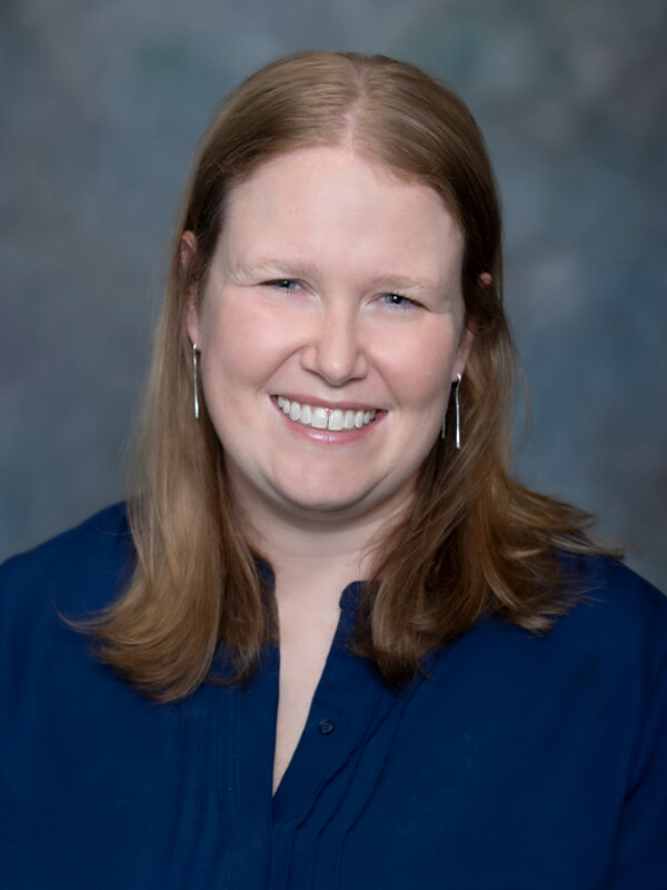 Headshot of Janet Rasmussen, pediatrician at South Lake Pediatrics. Janet has light brown hair, is wearing a navy blue top, and is smiling at the camera.