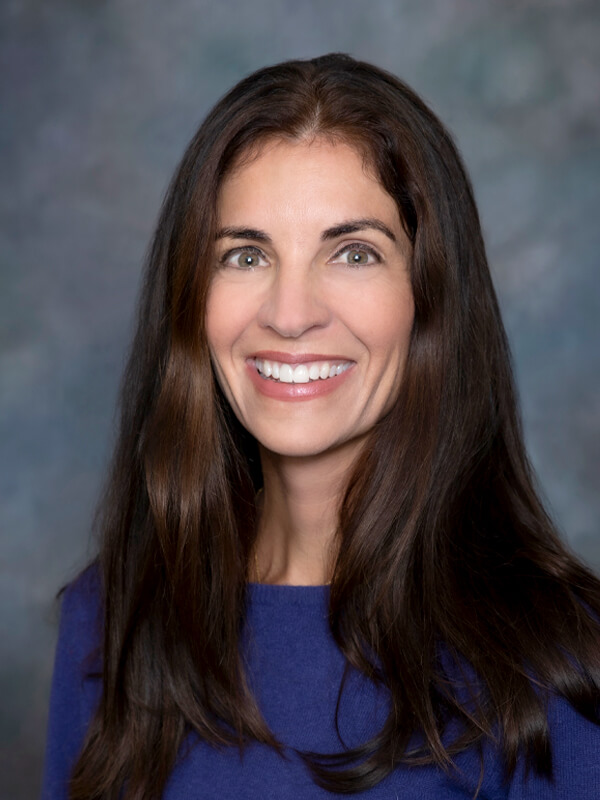 Headshot of Kathryn Schaefer, pediatrician at South Lake Pediatrics. Kathryn has long brown hair, is wearing a blue top, and is smiling at the camera.