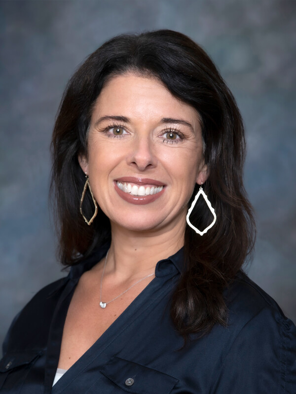 Headshot of Lorene Freehill, pediatrician at South Lake Pediatrics. Lorene has shoulder-length blonde hair, is wearing a mint green top, and is smiling at the camera.