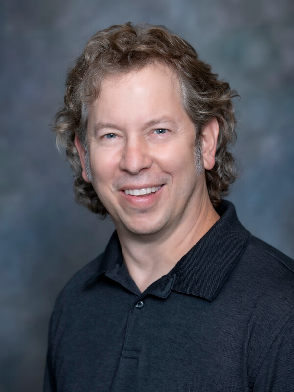 Headshot of Matthew Segedy, pediatrician at South Lake Pediatrics. Matthew has short blonde hair, is wearing a light blue shirt, and is smiling at the camera.