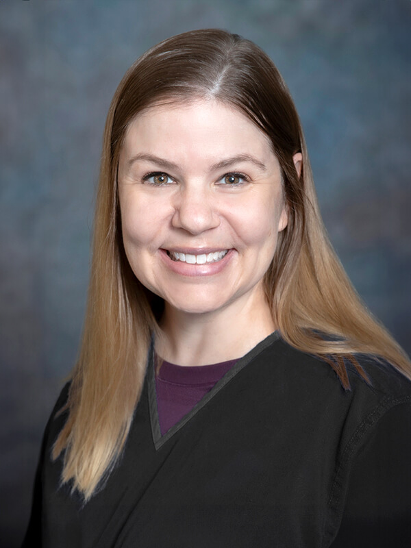 Headshot of Tracy Hall, pediatrician at South Lake Pediatrics. Tracy has straight light brown hair, is wearing a dark top, and is smiling at the camera.