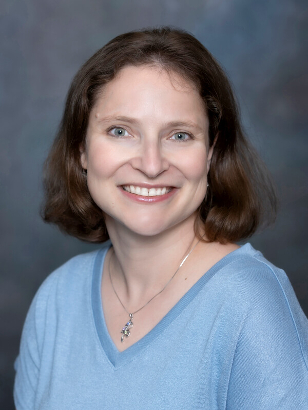 Headshot of Yana Nagle, pediatrician at South Lake Pediatrics. Yana has short brown hair, is wearing a light blue top, and is smiling at the camera.